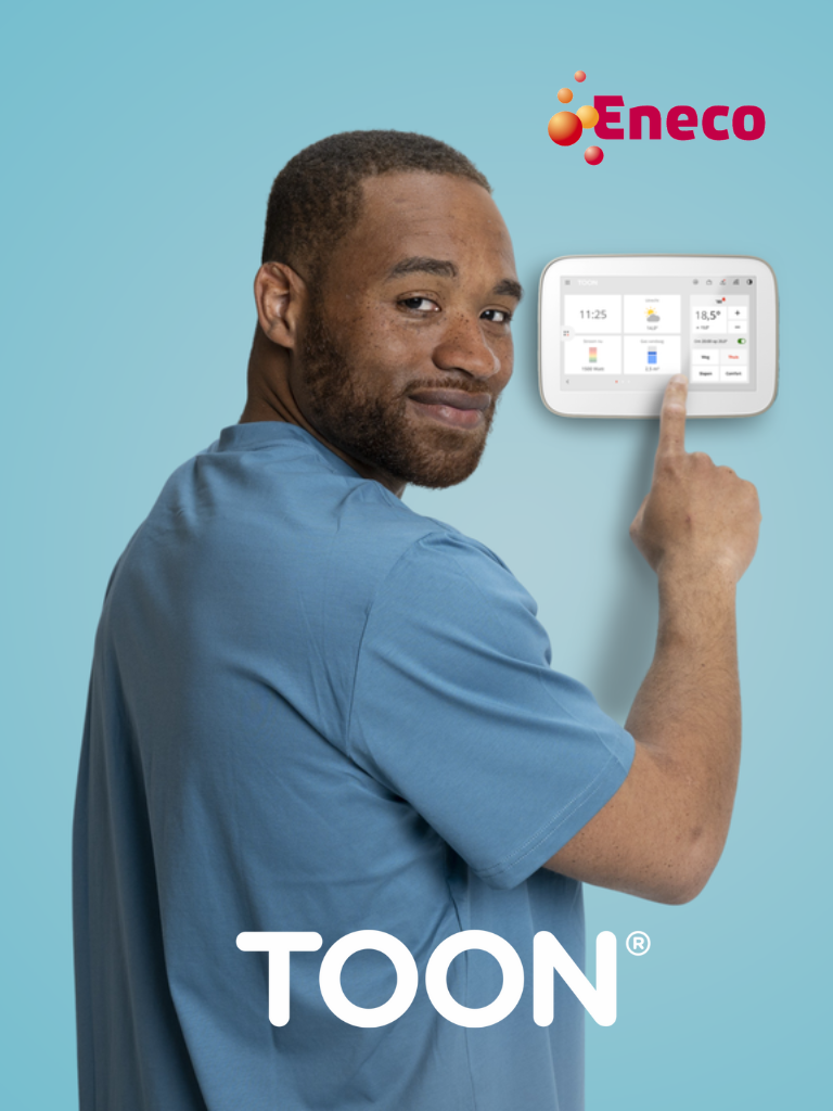A man interacting with a Toon smart thermostat mounted on a wall, representing Eneco's innovative energy solutions.